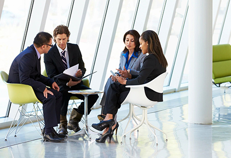 A group of people sitting around each other.